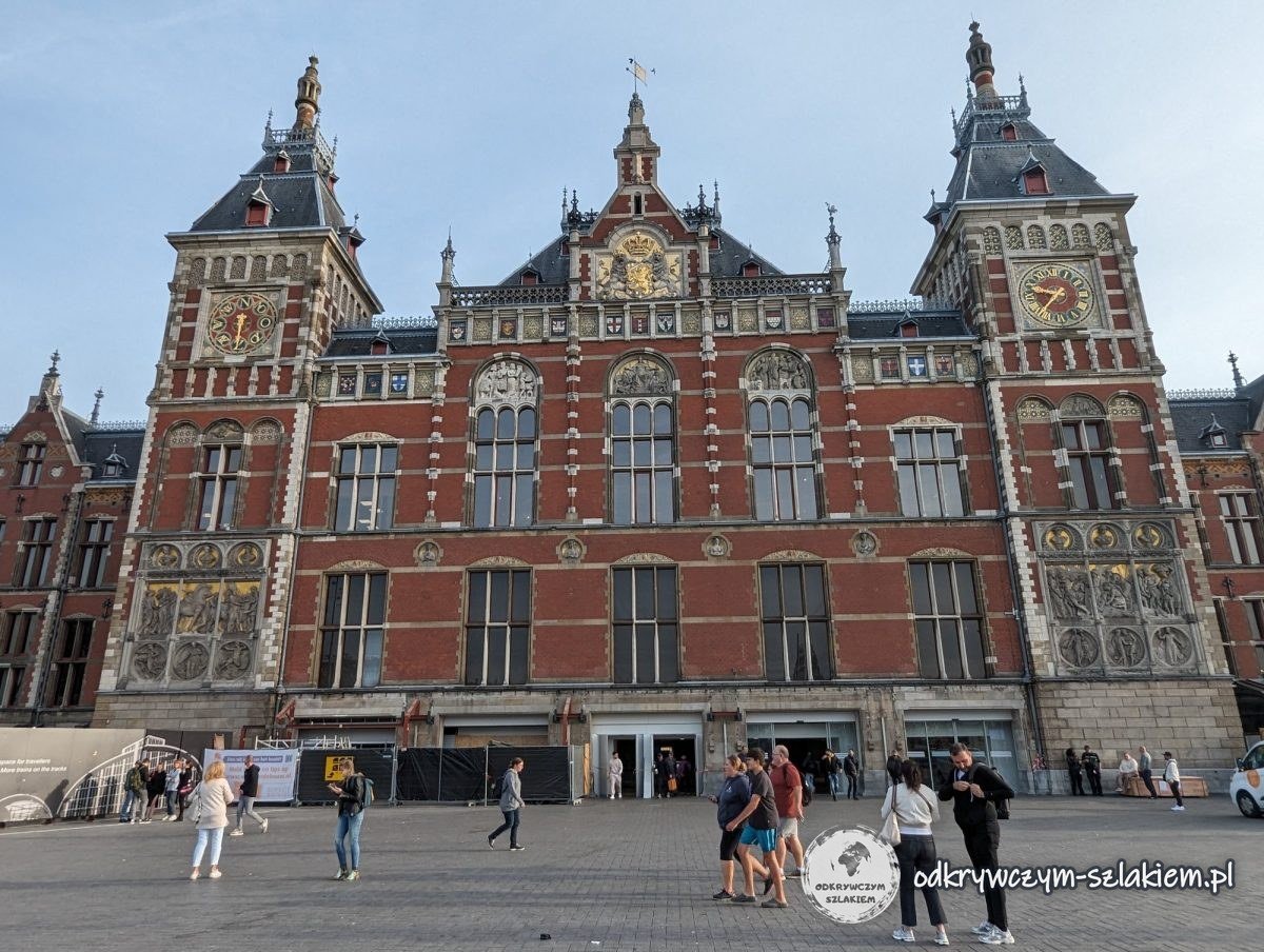 Brick façade of Amsterdam Centraal station with two towers and clocks