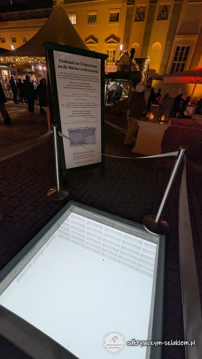 Illuminated glass pane in the Bebelplatz pavement with a view of empty white shelves – the “Bibliothek” memorial to the 1933 book burning