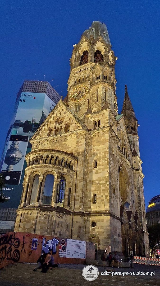 The ruined tower of the Kaiser Wilhelm Memorial Church lit up in the evening