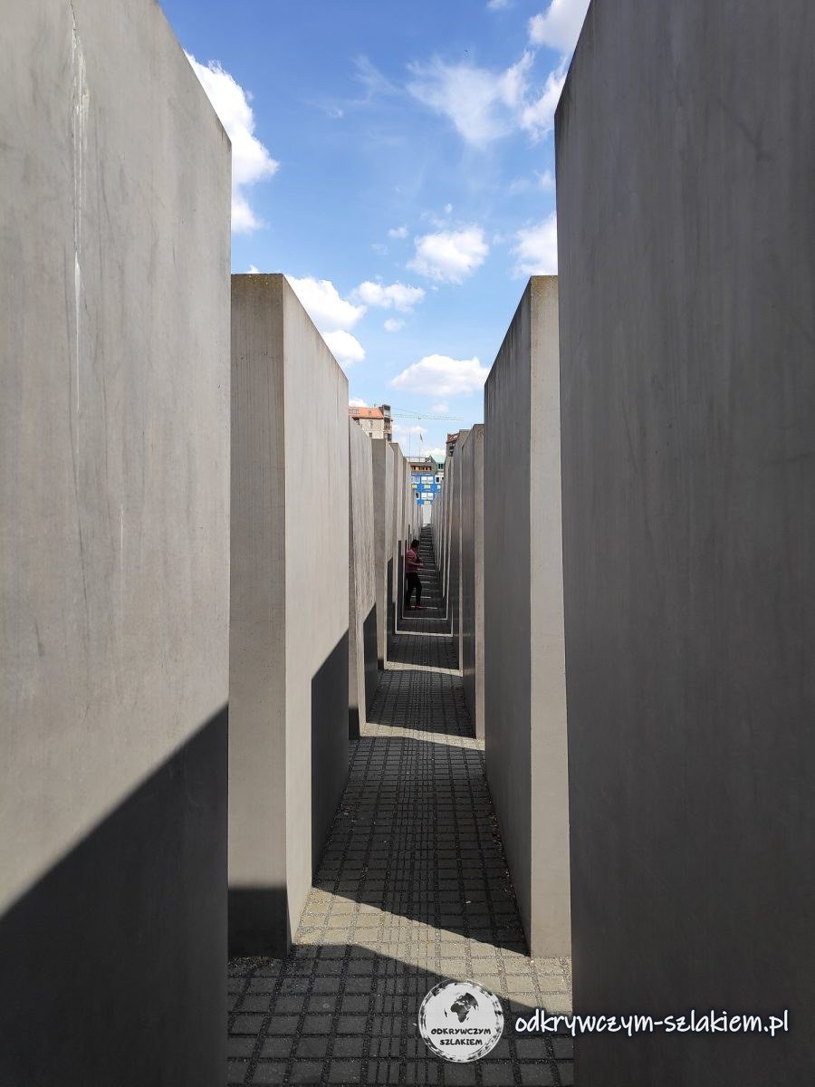 A narrow path between tall concrete blocks of the Memorial to the Murdered Jews of Europe