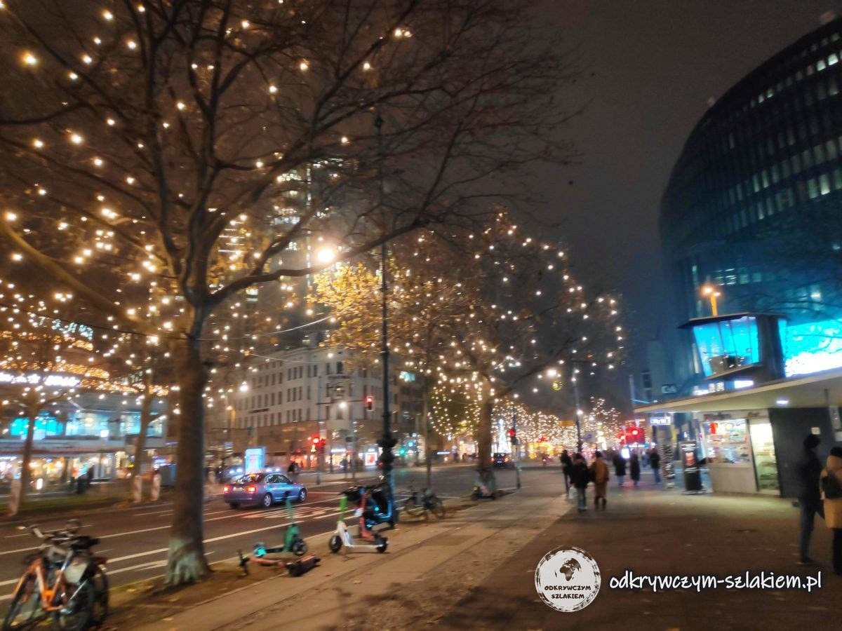 Árboles con luces navideñas en el Kurfürstendamm al anochecer