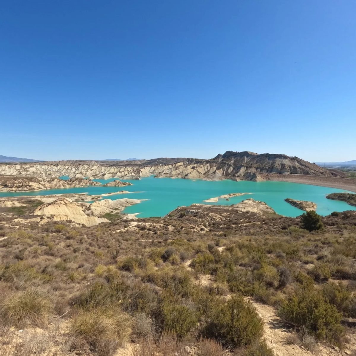 Turkusowy zbiornik Embalse de Algeciras wśród suchych wzgórz w regionie Murcji