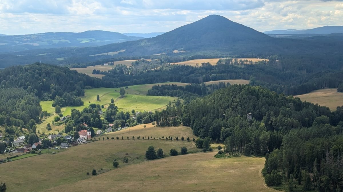 Růžovský vrch widziany z oddali ze skalnego punktu widokowego nad wioską