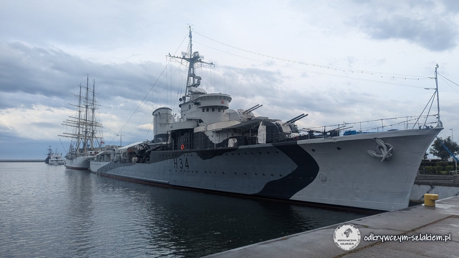 The destroyer ORP Błyskawica at the South Pier quay in Gdynia, with the sailing ship Dar Pomorza in the background