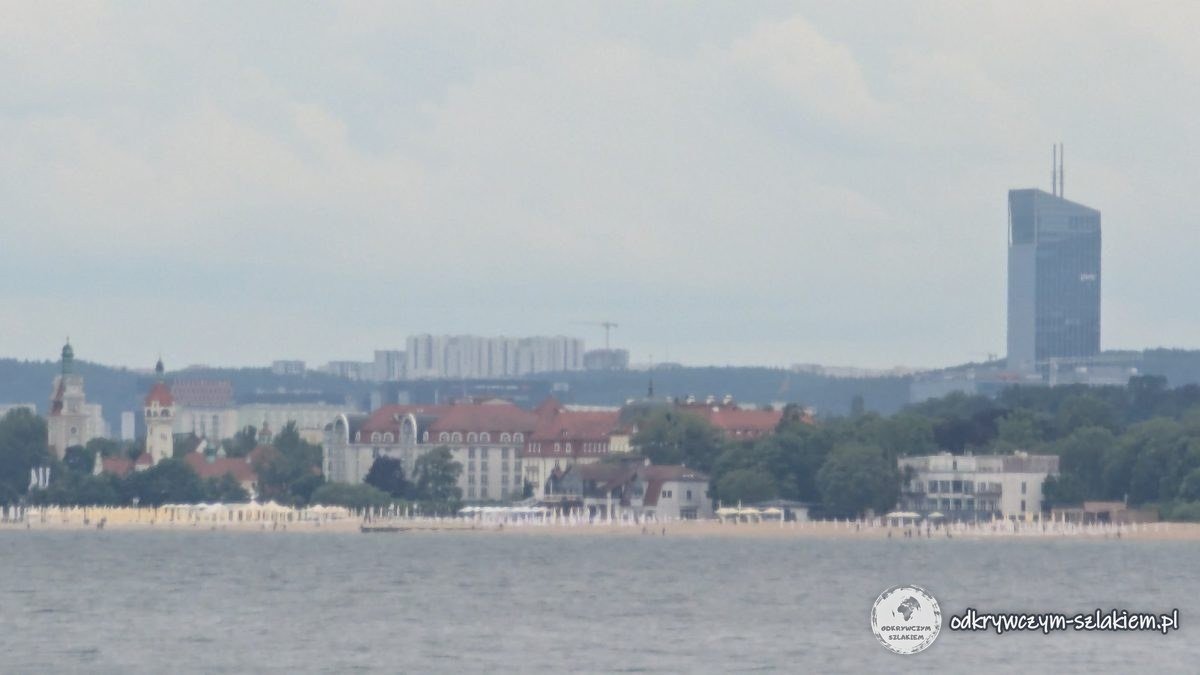 The beach and buildings of Sopot with the Olivia Star skyscraper behind, seen from the Orłowo pier