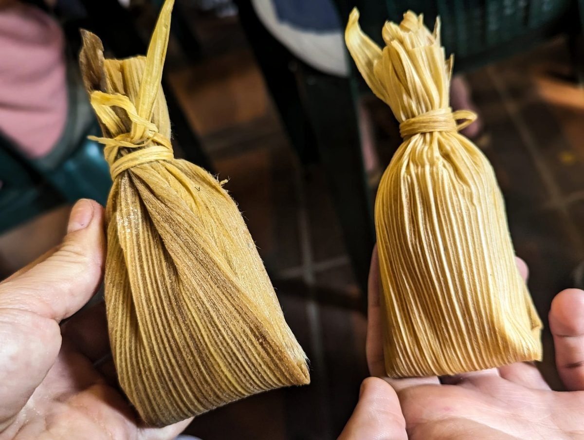 Dwa przysmaki zawinięte w liście kukurydzy, trzymane w dłoniach – Antigua Guatemala