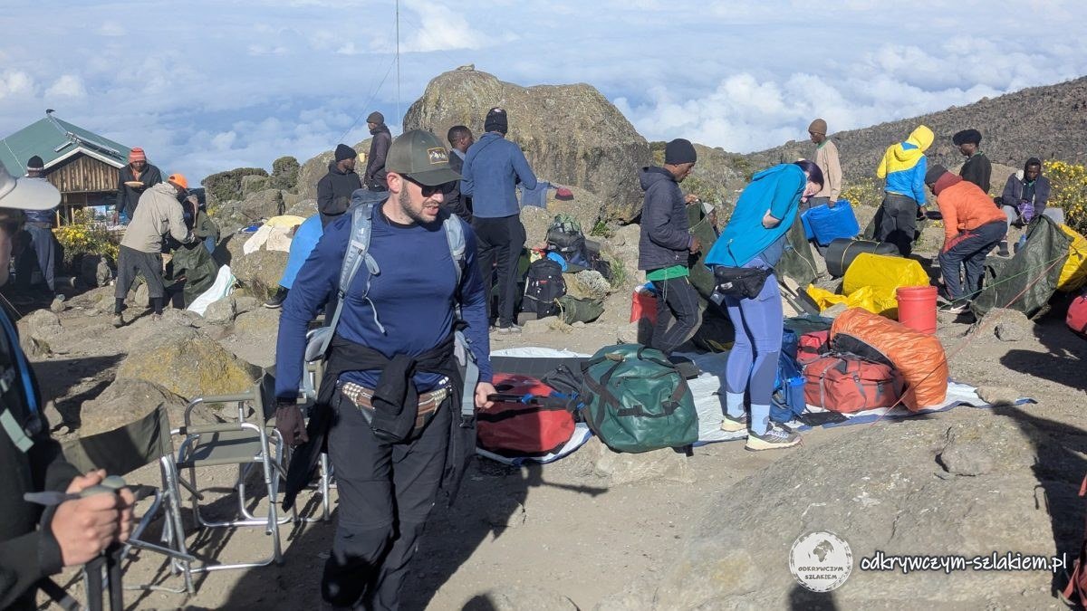 Poranek w Karanga Camp – tragarze pakują obóz i bagaże przed wymarszem
