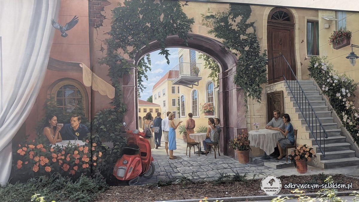 Mural udający przejście przez bramę na słoneczną uliczkę z kwiatami w Łodzi