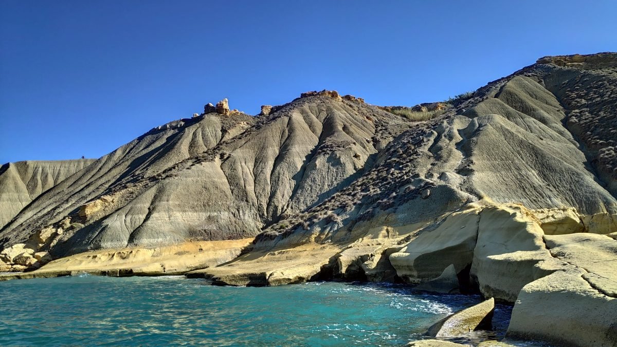 Gliniane klify (Clay Cliffs) opadające do turkusowej zatoki na zachodnim wybrzeżu Malty