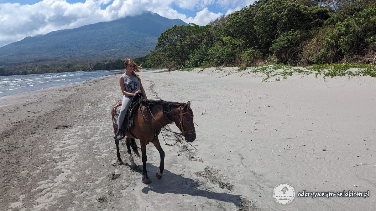 Patrycja na przejażdżce konnej po plaży na Ometepe, w tle wulkan Maderas