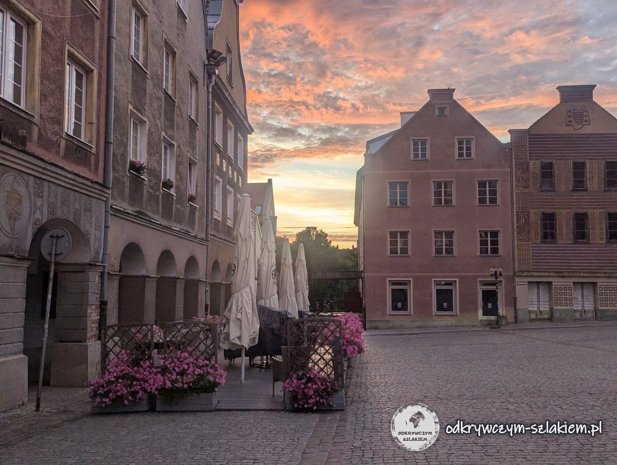Arcaded town houses on Olsztyn's Market Square at sunset