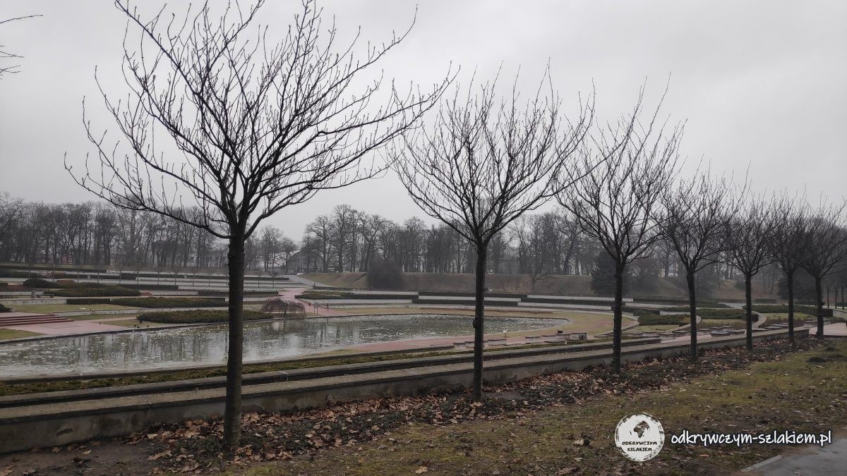 The terraces of the rose garden with a pond and leafless trees in Citadel Park in Poznań in winter
