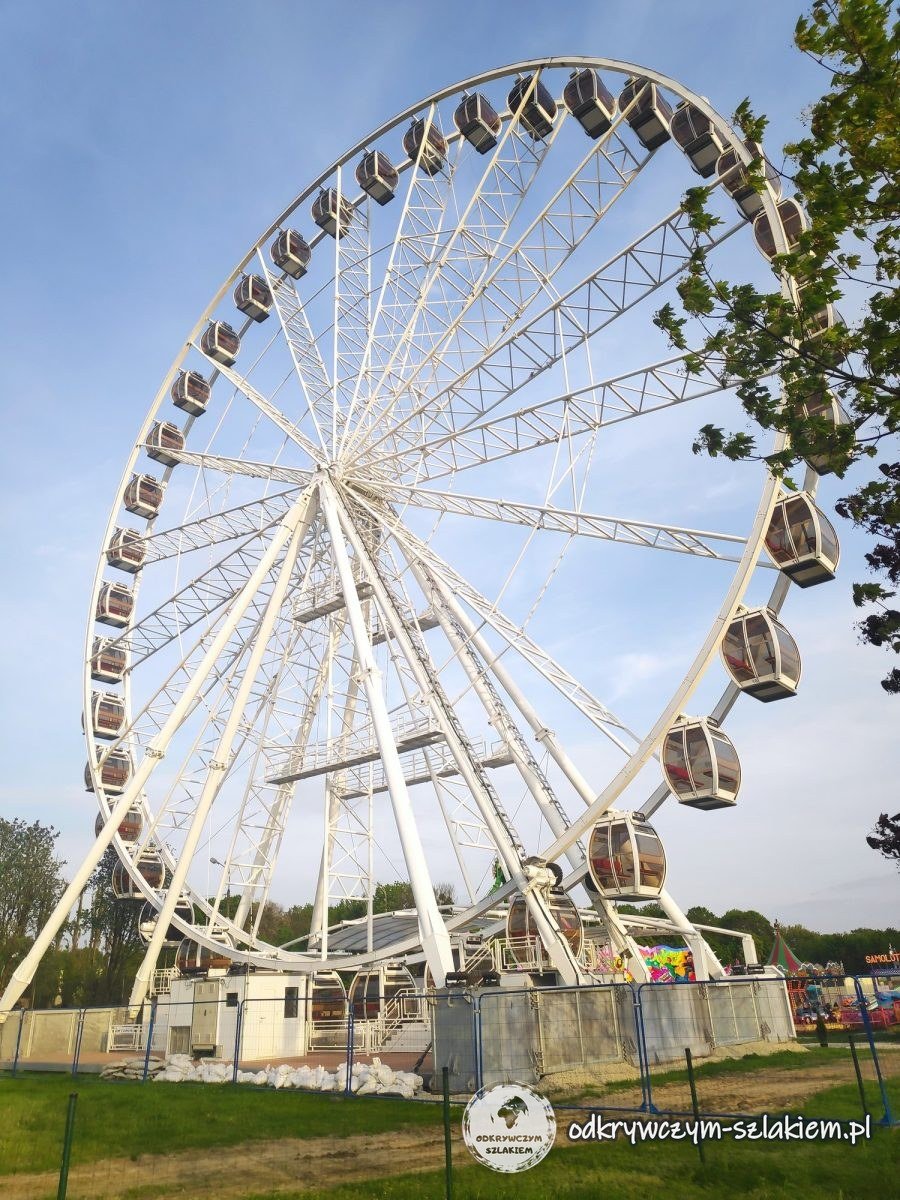 A white Ferris wheel of a funfair in Winogrady, Poznań, against the sky