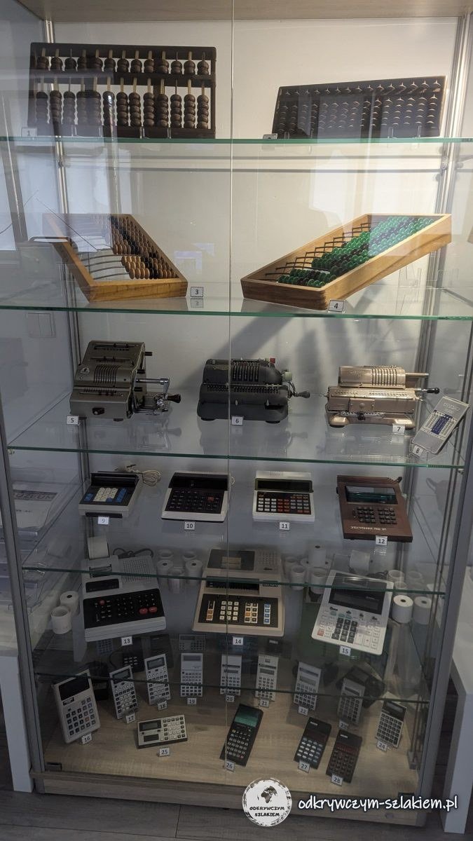 A display case with wooden abacuses, mechanical calculators and pocket calculators in the games museum in Poznań