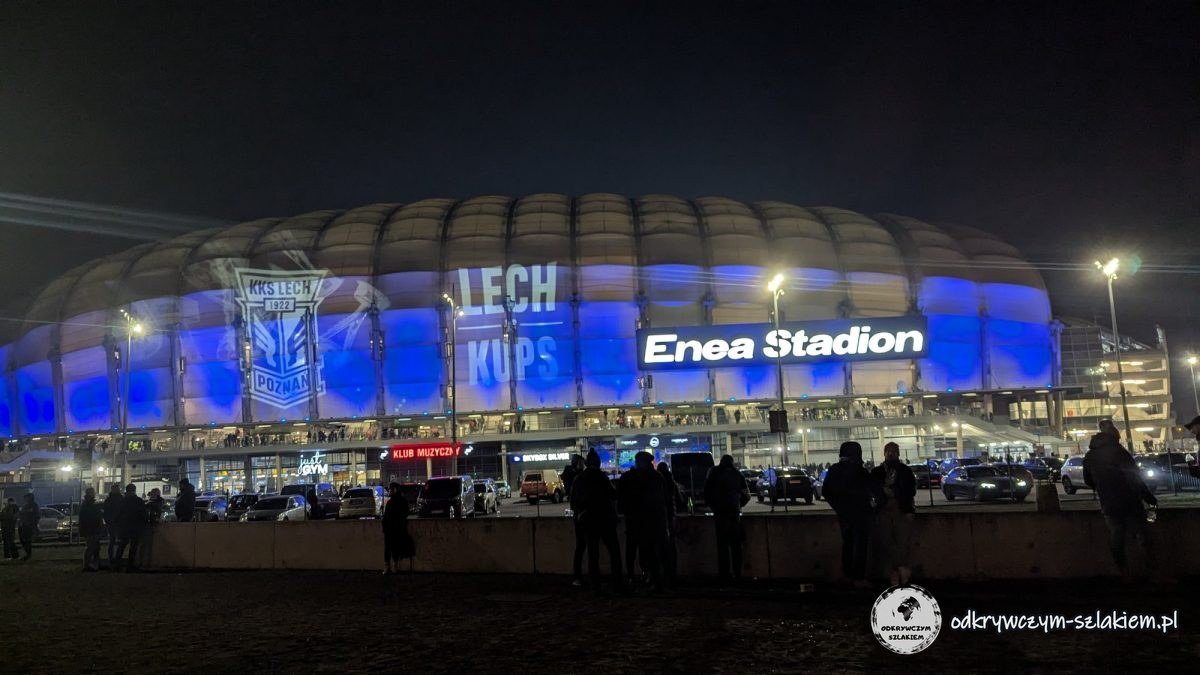 Enea Stadion in Poznań lit up in blue at night with the words LECH and KUPS before the match