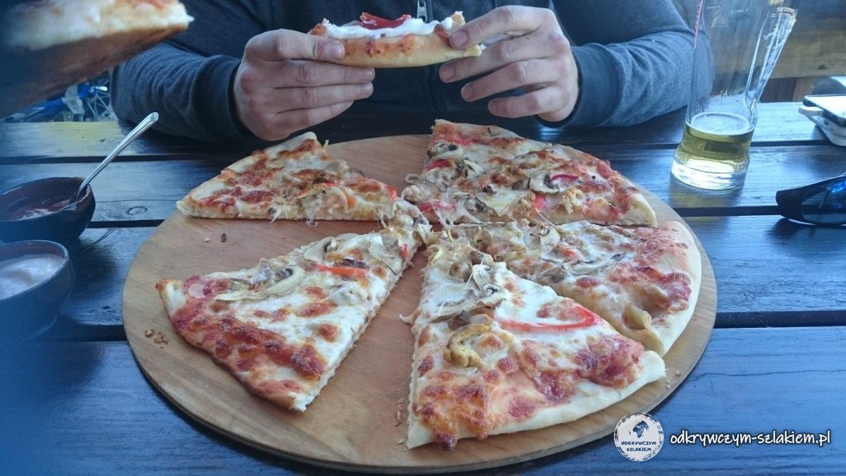 Pizza na drewnianej desce podczas postoju w drugim dniu wyprawy
