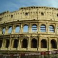 El Coliseo de Roma con el sol de la tarde y una valla de las obras de la línea C del metro