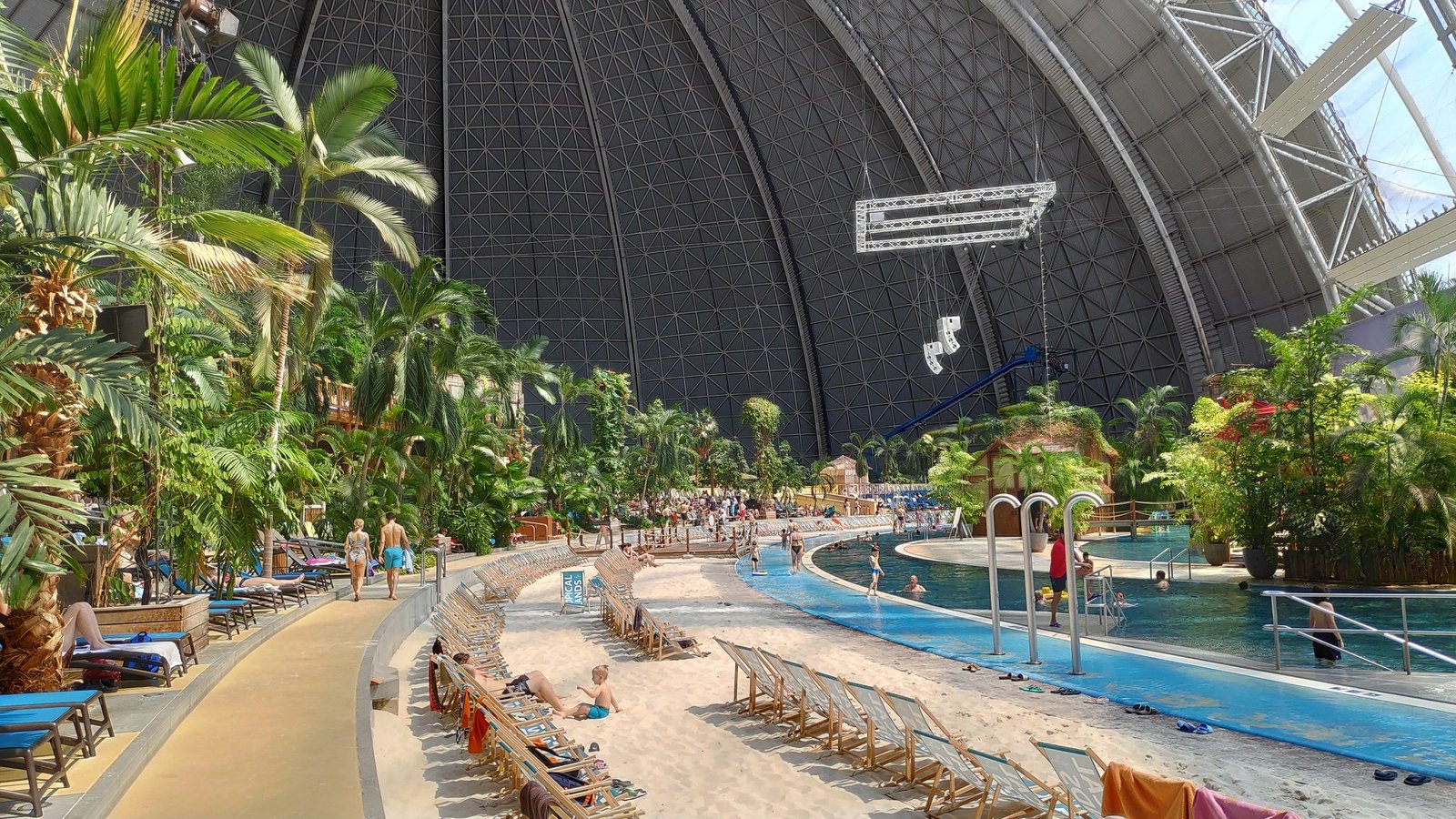 Basen z piaszczystą plażą i leżakami pod kopułą hali – Tropical Islands