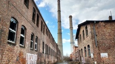 Ceglane hale i wysokie kominy opuszczonej fabryki włókien sztucznych w Szczecinie